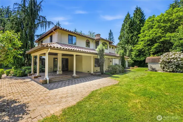 Large patio with winding path to a covered gazebo.