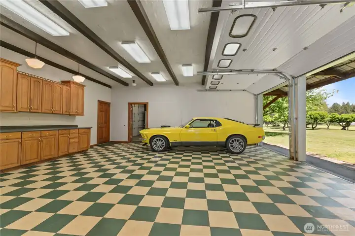 Outbuilding 1: Show room with two garage doors. Space for 2+ cars.