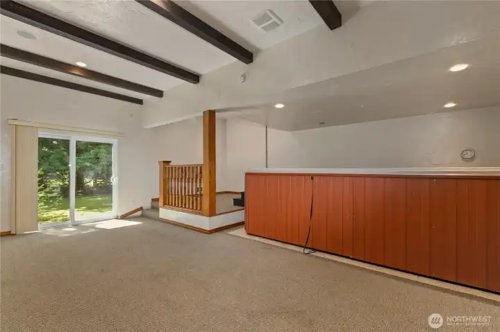 Outbuilding 1: 17'x9' hot tub and swim spa. Not pictured is the garage door entry across from the slider. This room is perfect as a gym, party area, spa or car show room if you remove the hot tub.