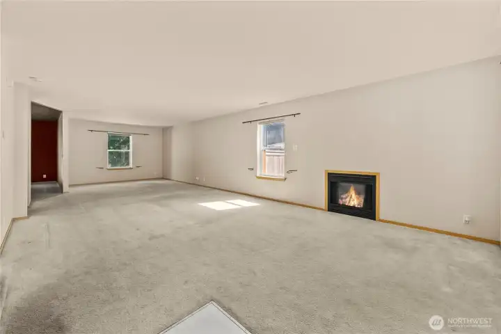 As you enter, the large living room offers a gas fireplace.