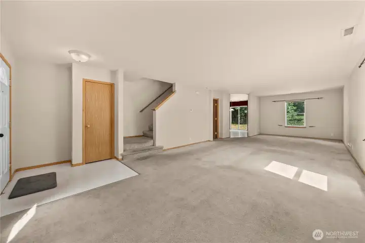 Showing the front door, coat closet, and stairs to the 2nd level.