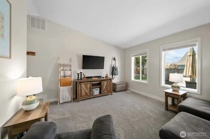Living room with vaulted ceilings.