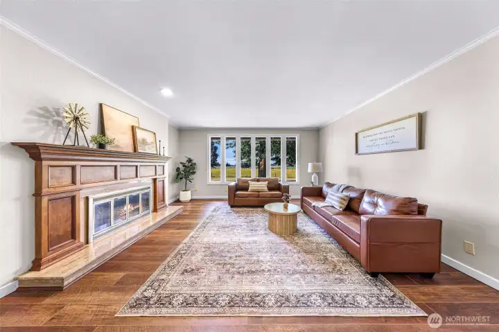 Living room with beautiful 2 sided wood fireplace.