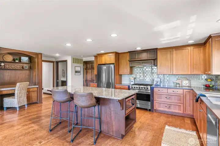 another view of kitchen, eating area and desk area.