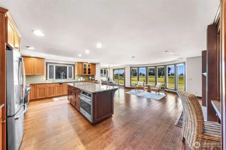This shot shows the large family room, feature rounded windows and view of the fields to the south.