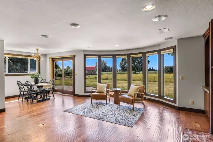 Family area with dining room and wall of windows with views to the south.