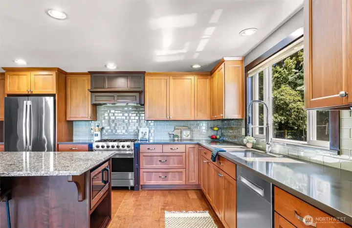 Kitchen with ample cabinets, stainless appliances complete with undermount sink. Enjoy the large window bringing in lots of light.