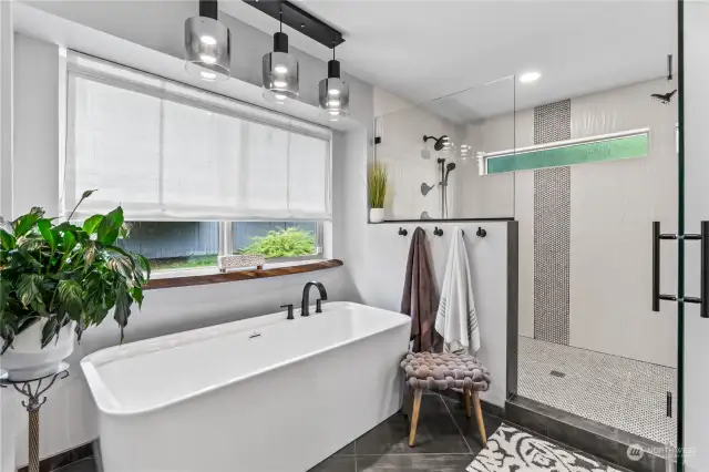 Primary Bathroom feels like a Spa retreat.  Oversized tub, walk-in shower with extra thick glass has double shower heads and a bench with an alcove for products.
