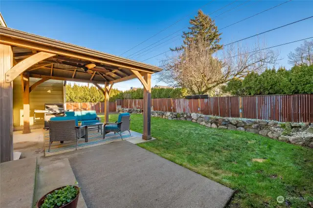 Decorative metal fence and rock beds give this backyard so much character!