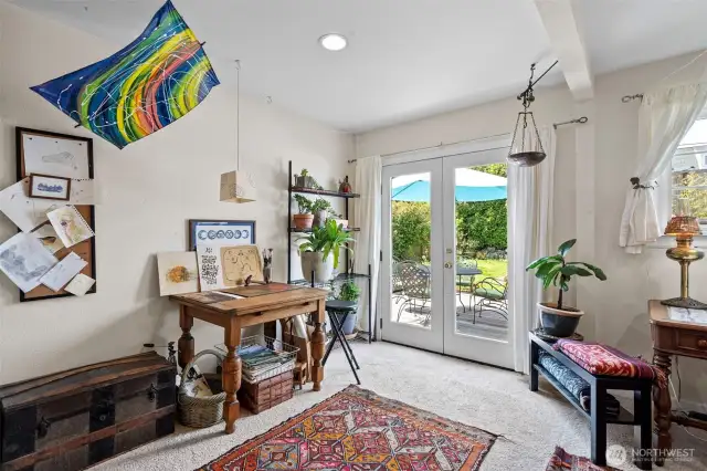 French doors lead to back deck and beautiful gardens.