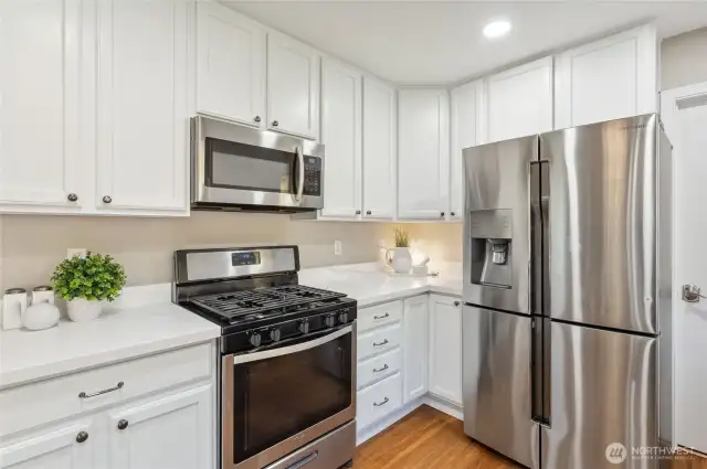 Stainless steel appliances & a 5-burner gas range.