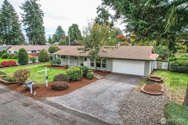 Beautifully landscaped with grassy yard, raised flower beds, paved walkways, ample off-street parking & quality paint job