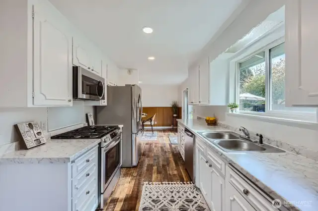 Large window makes this area bright & inviting. Enjoy the natural setting outdoors while you do dishes