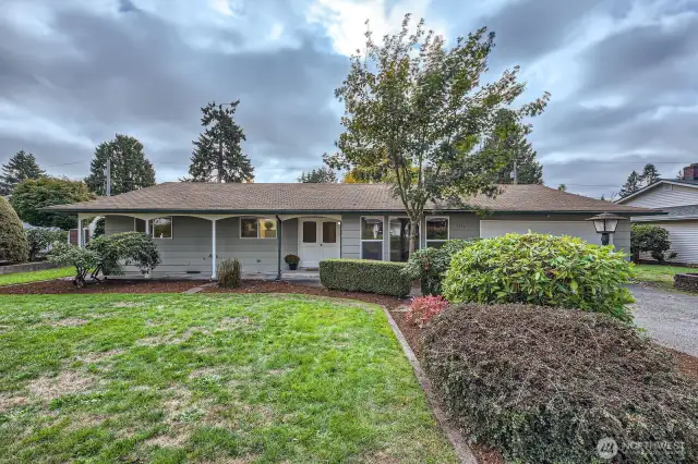 Ever dreamed of a porch swing? Maybe rocking chairs? This covered porch is oversized & great for relaxing, hanging baskets & watching the kids play