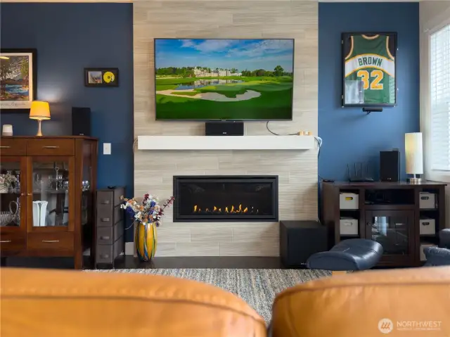 Custom tiled upgraded gas Fireplace with room for any flat screen TV to hang above.