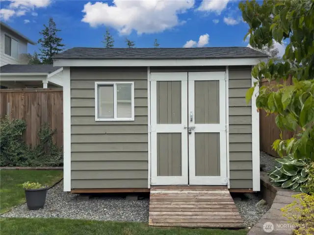 Professionally built and installed garden shed with ramp for mower.