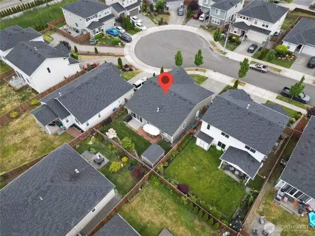 Aerial view of a fully fenced in South facing rear yard.