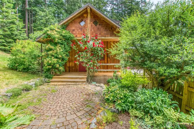A brick patio provides a welcoming approach to the home.