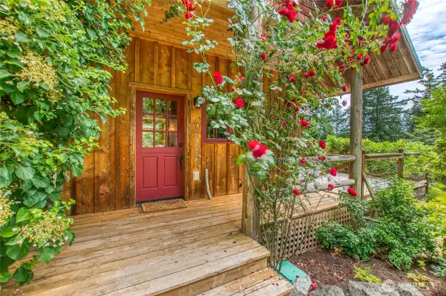 A charming Dutch door opens onto a wraparound deck that leads to the living room.