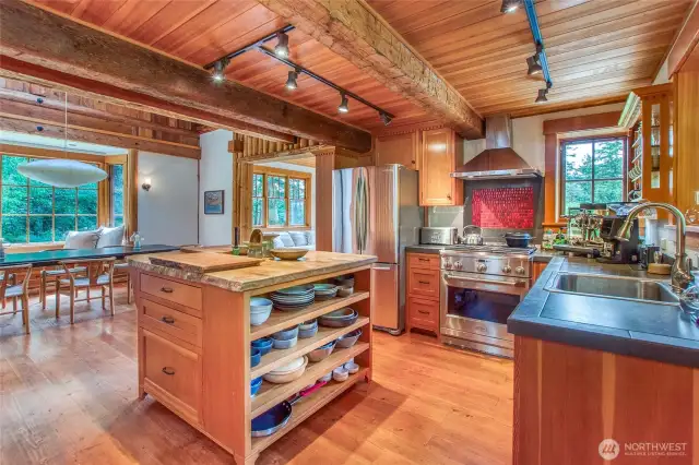 The kitchen features a large island with built-in storage and seating for two