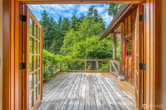 French doors in the living room open onto a spacious deck overlooking the grounds.