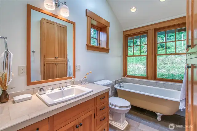 The clawfoot tub in the primary ensuite bath offers a serene, spa-like retreat.