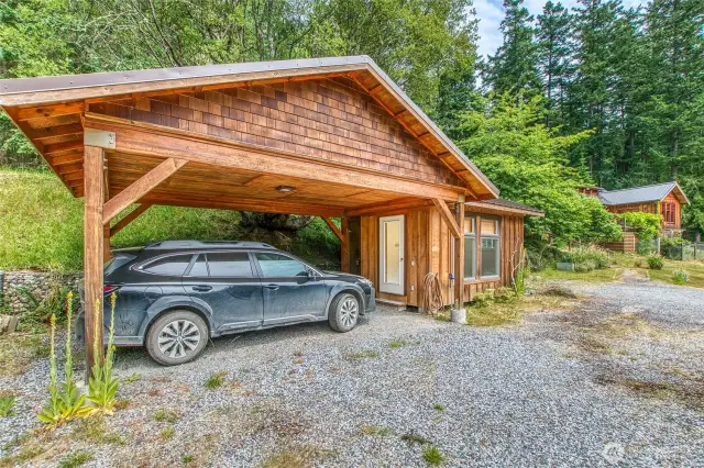 The carport provides protection for your vehicle and is attached to the additional studio space.