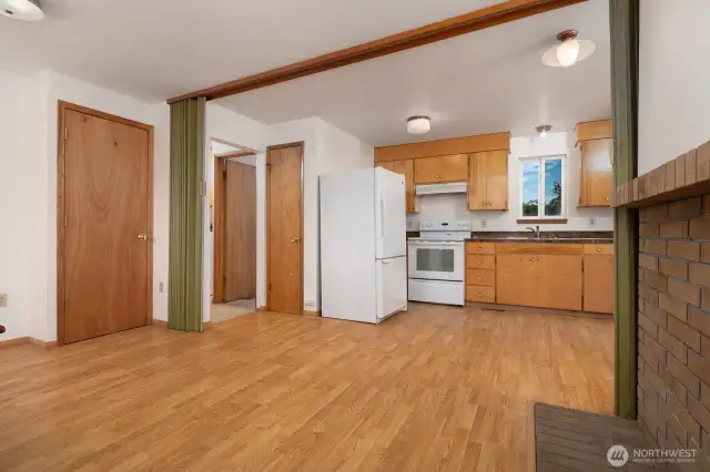Another angle from the dining room that shows the furnace and pantry closets. The pantry is located behind the fridge and the furnace is behind the door on the left of the room.