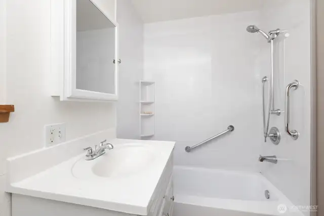 Recently updated vanity, medicine cabinet and shower and tub enclosure. Handrails have been installed in the shower for added accessibility.