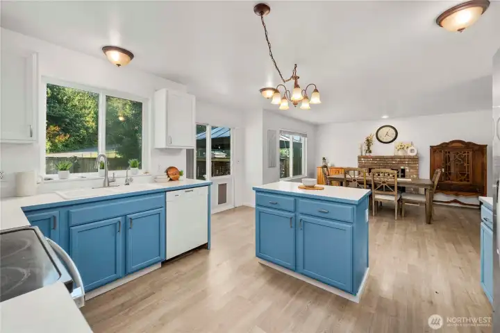 Open-concept kitchen and living room with a versatile second living space currently used as a dining room
