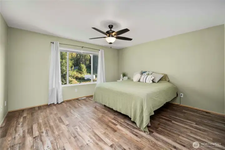 Spacious primary bedroom with abundant natural light and durable, easy-maintenance LVP flooring