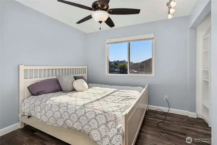 Bedroom #2 features modern paint colors, built-in storage, and a ceiling fan for comfort