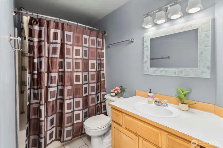 Well-appointed guest bathroom situated on the upper level
