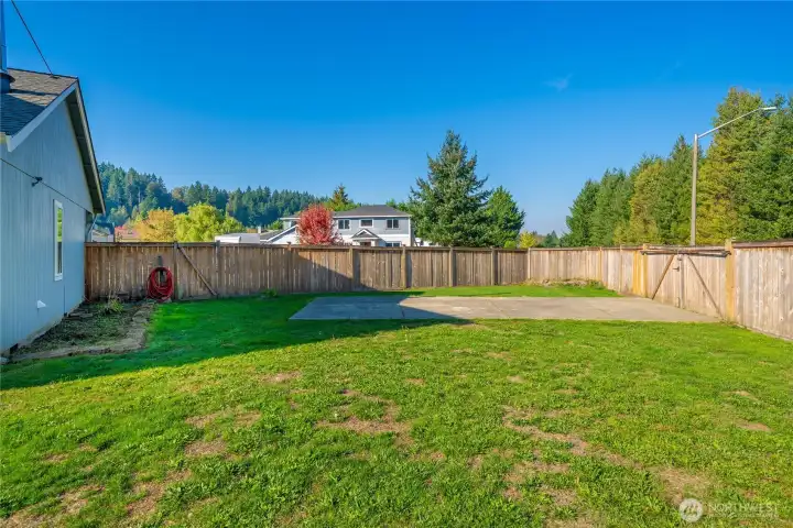 Large side yard features a separate gate and concrete parking pad—ideal for RVs, boats, or trailers