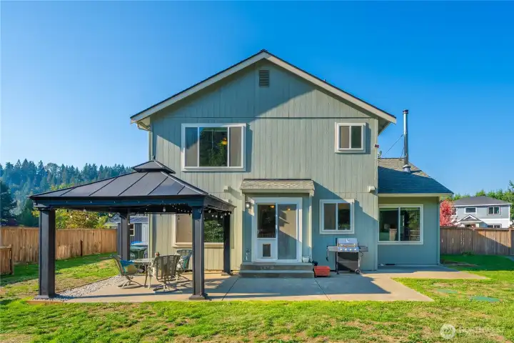 View of the home’s rear elevation and outdoor living spaces