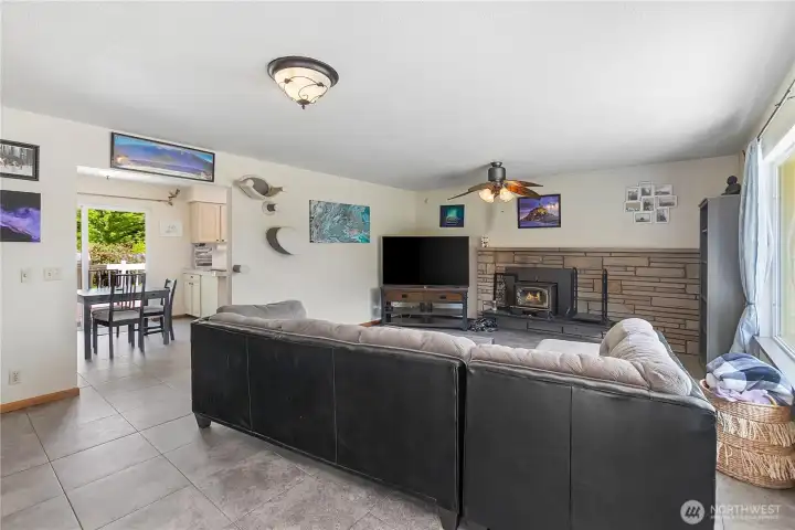 Living room with fireplace with wood insert stove new vinyl planked flooring