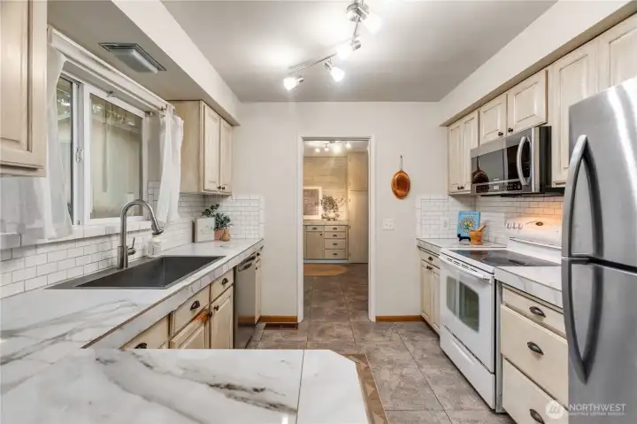 Kitchen with new refer, dishwasher towards laundry