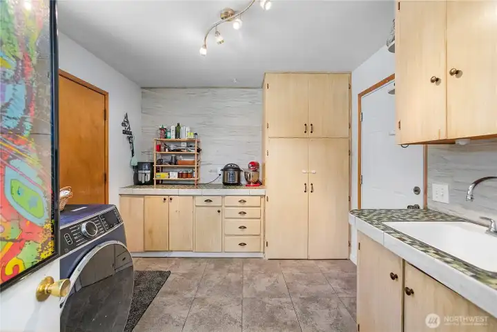 Laundry room with tons of cabinets and laundry sink