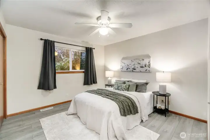 Primary Bedroom with ceiling fan and double closets
