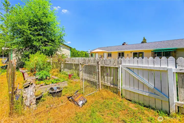 Garden area behind fence in back yard