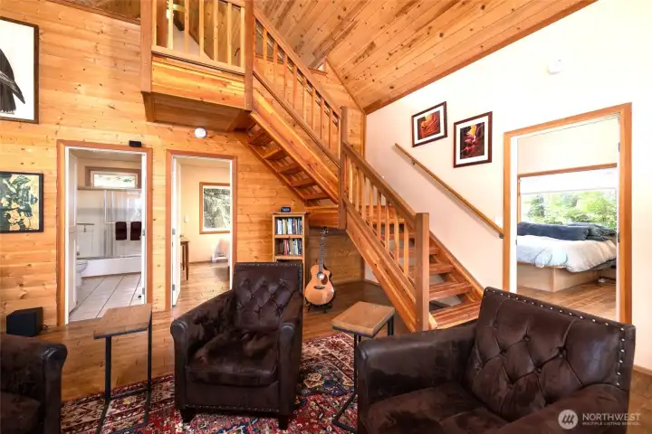 View from living area of second bathroom, bedroom and stairs to loft