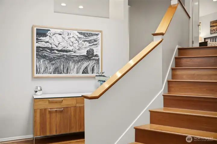 Light filled layout with vaulted ceilings and rich hardwood floors.