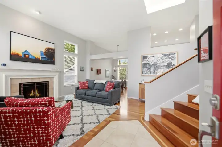 Main floor living room with vaulted ceilings and gas fireplace.