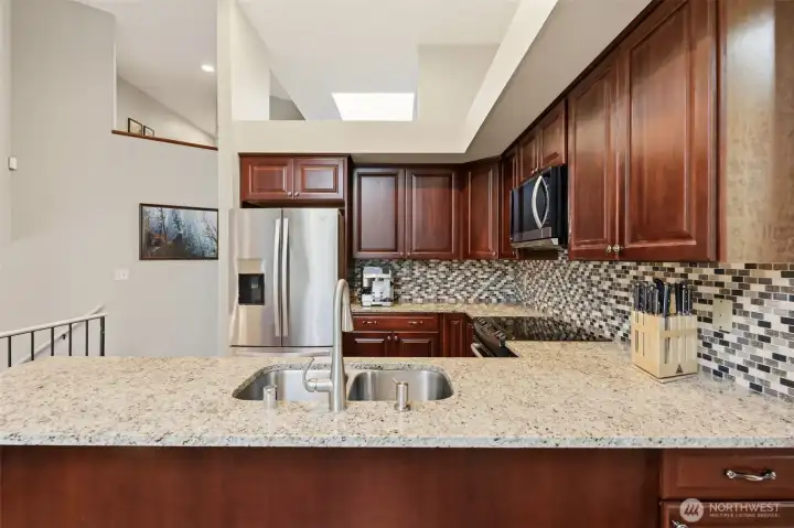 Kitchen features granite countertops and stainless appliances