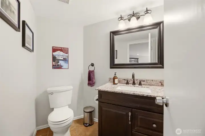 Lower level guest bathroom located next to office and garage
