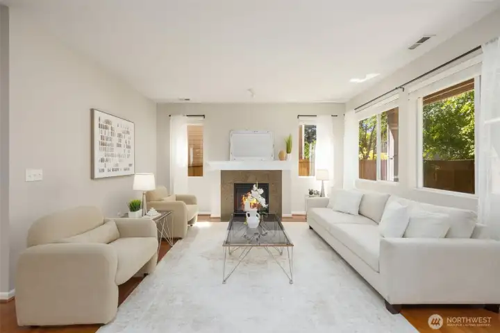 Rich hardwoods through the main floor into a cozy living room anchored by a warm fireplace.