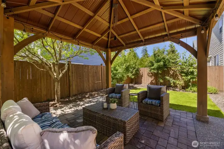 Fenced backyard featuring a charming gazebo in an east facing house perfect for PNW evenings.