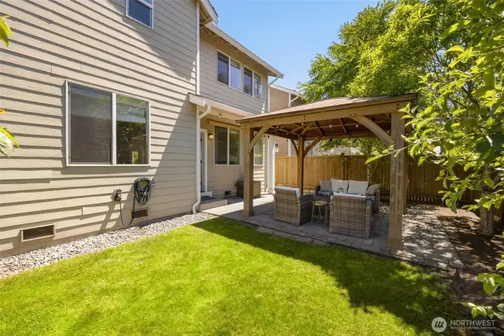 Fenced backyard featuring a charming gazebo in an east facing house perfect for PNW evenings.