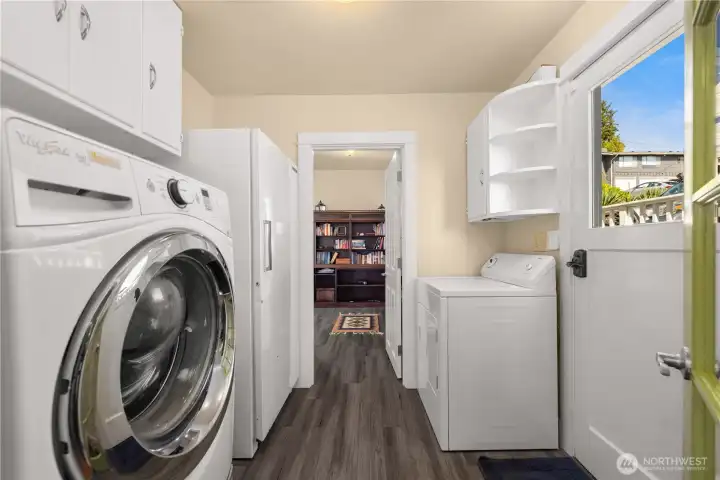 Laundry room just off the kitchen. Door leads to a side deck and to the parking pad.