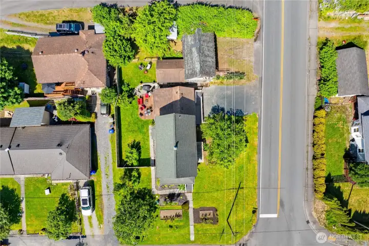 Property line goes to the green bushes on the West side of the carriage house.